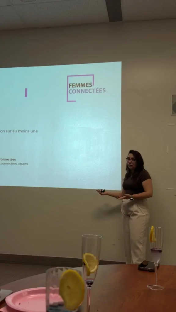Nadeje explaining AI beside a projected slide at the September session